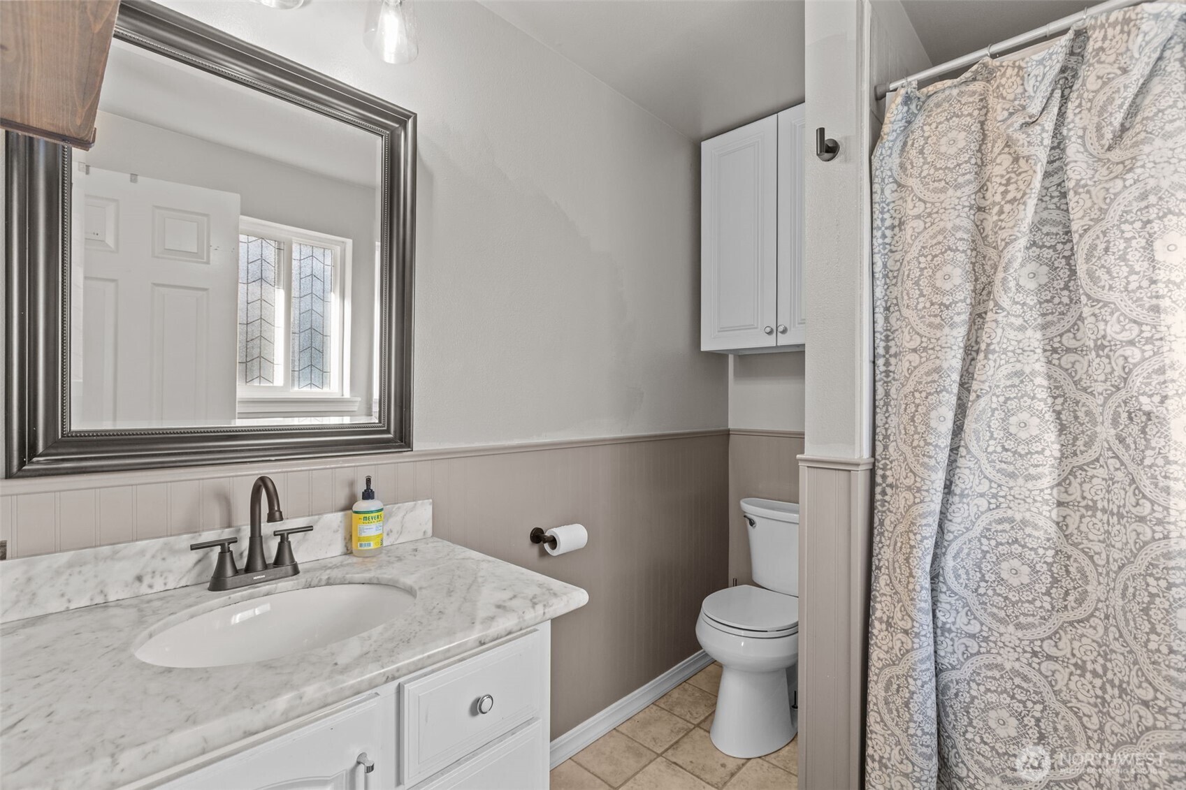 20911 Ronning Road Arlington, WA 98223 - Photo 19 of 40 a bathroom with a granite countertop toilet a sink and a mirror