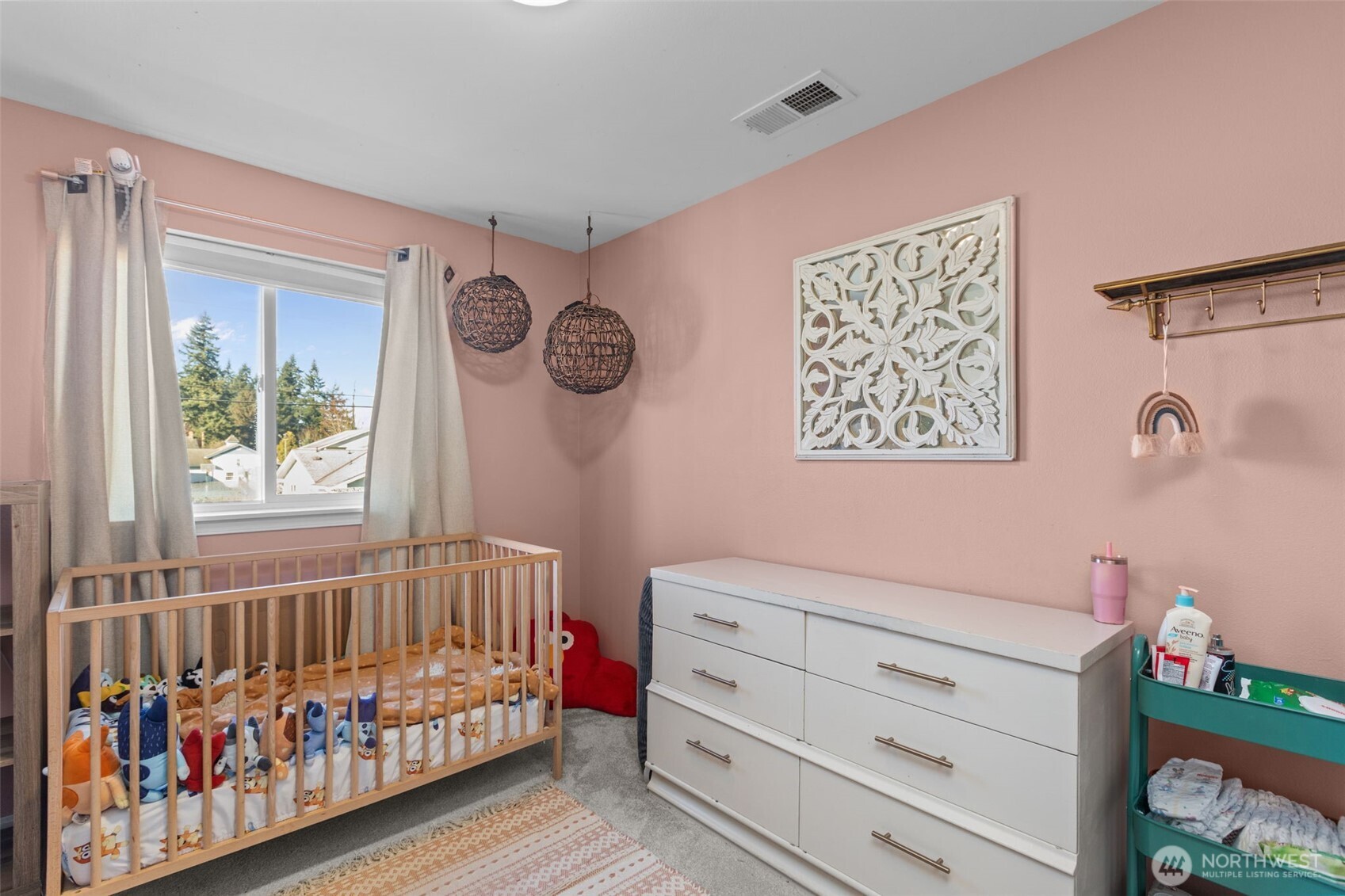 20911 Ronning Road Arlington, WA 98223 - Photo 21 of 40 a bedroom with a baby bed and a window