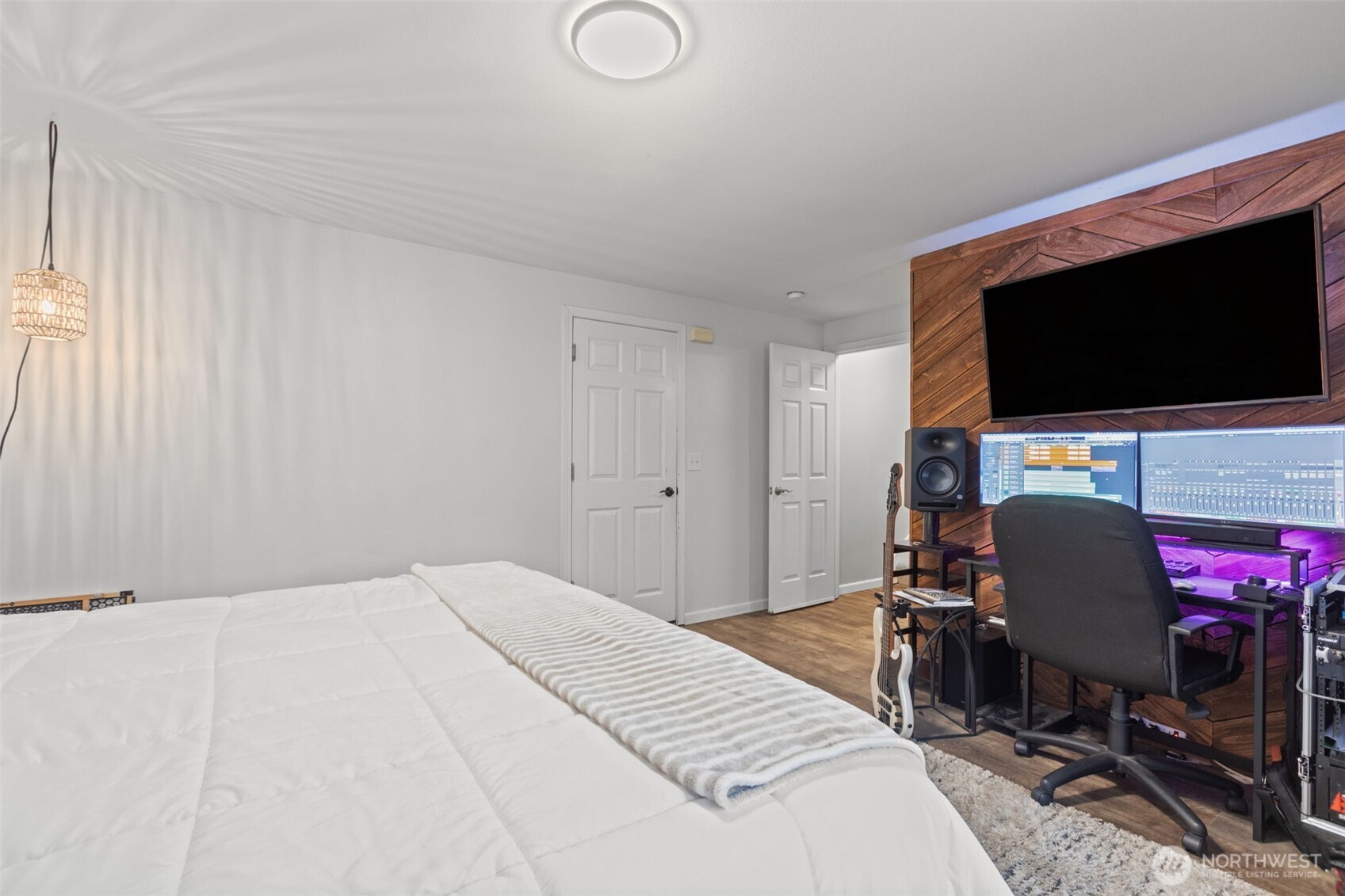 20911 Ronning Road Arlington, WA 98223 - Photo 30 of 40 a bedroom with a bed and a flat screen tv