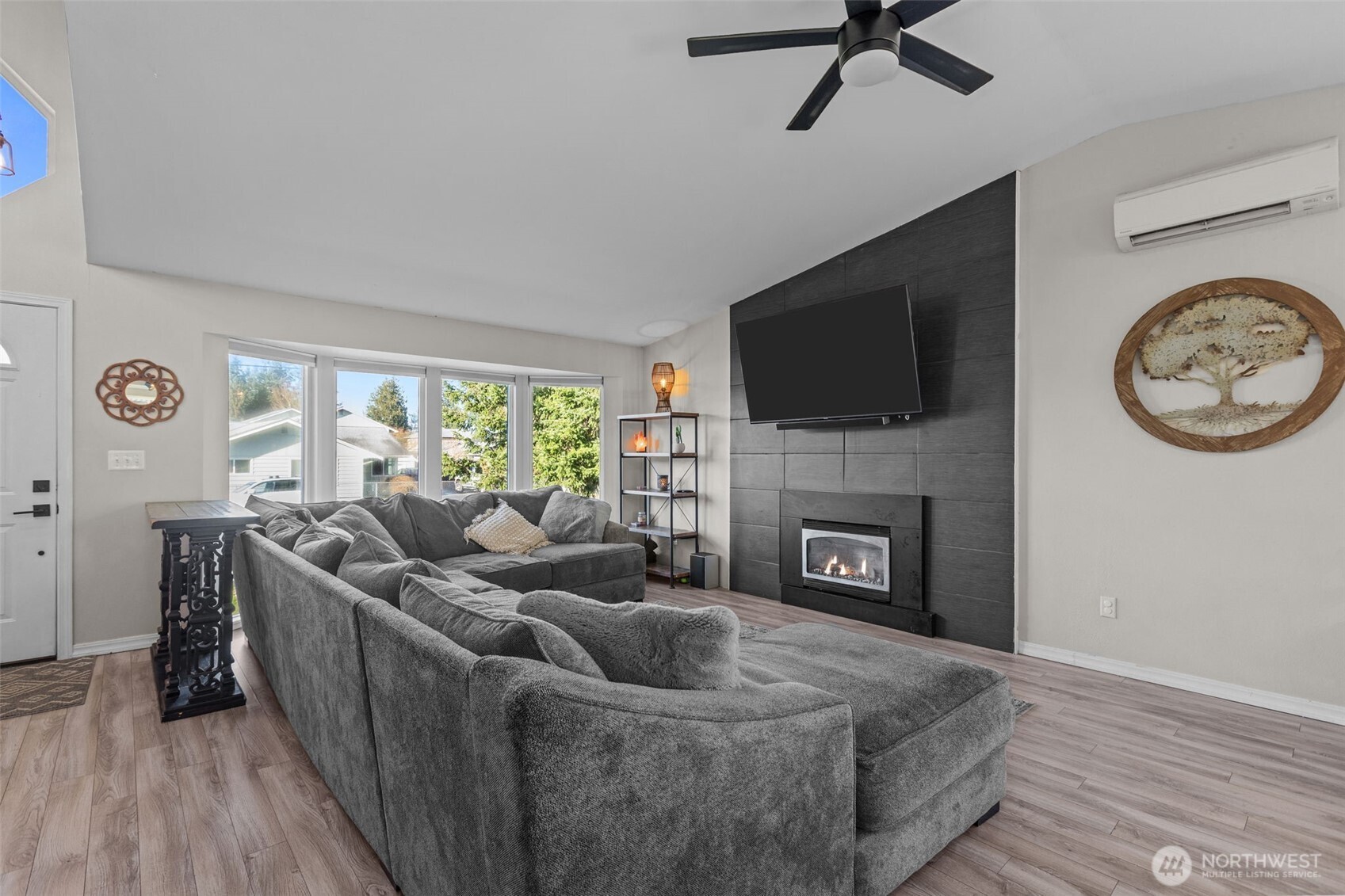 20911 Ronning Road Arlington, WA 98223 - Photo 3 of 40 a living room with furniture a fireplace and a flat screen tv