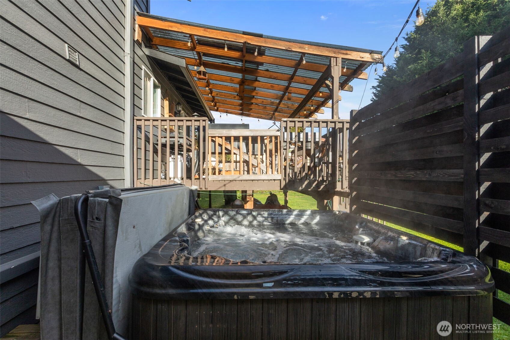 20911 Ronning Road Arlington, WA 98223 - Photo 33 of 40 a roof deck with table and chairs and wooden floor