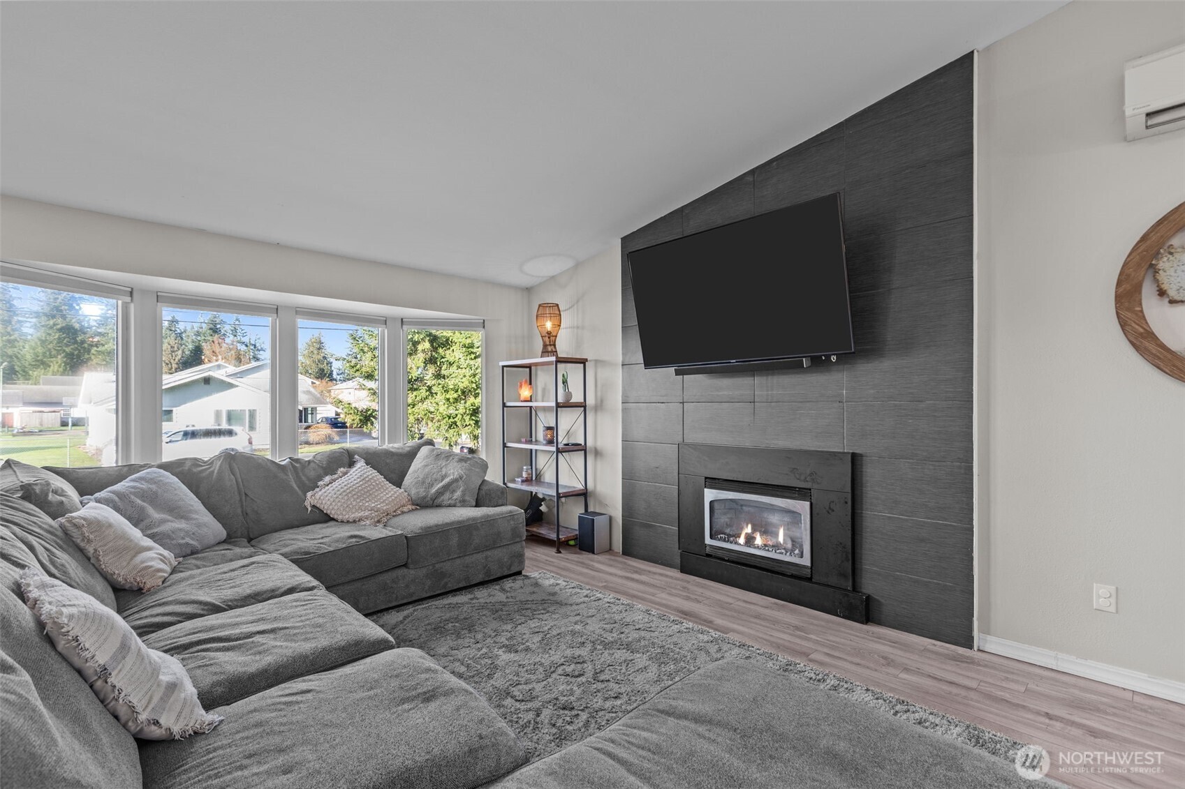 20911 Ronning Road Arlington, WA 98223 - Photo 40 of 40 a living room with furniture a flat screen tv and a fireplace