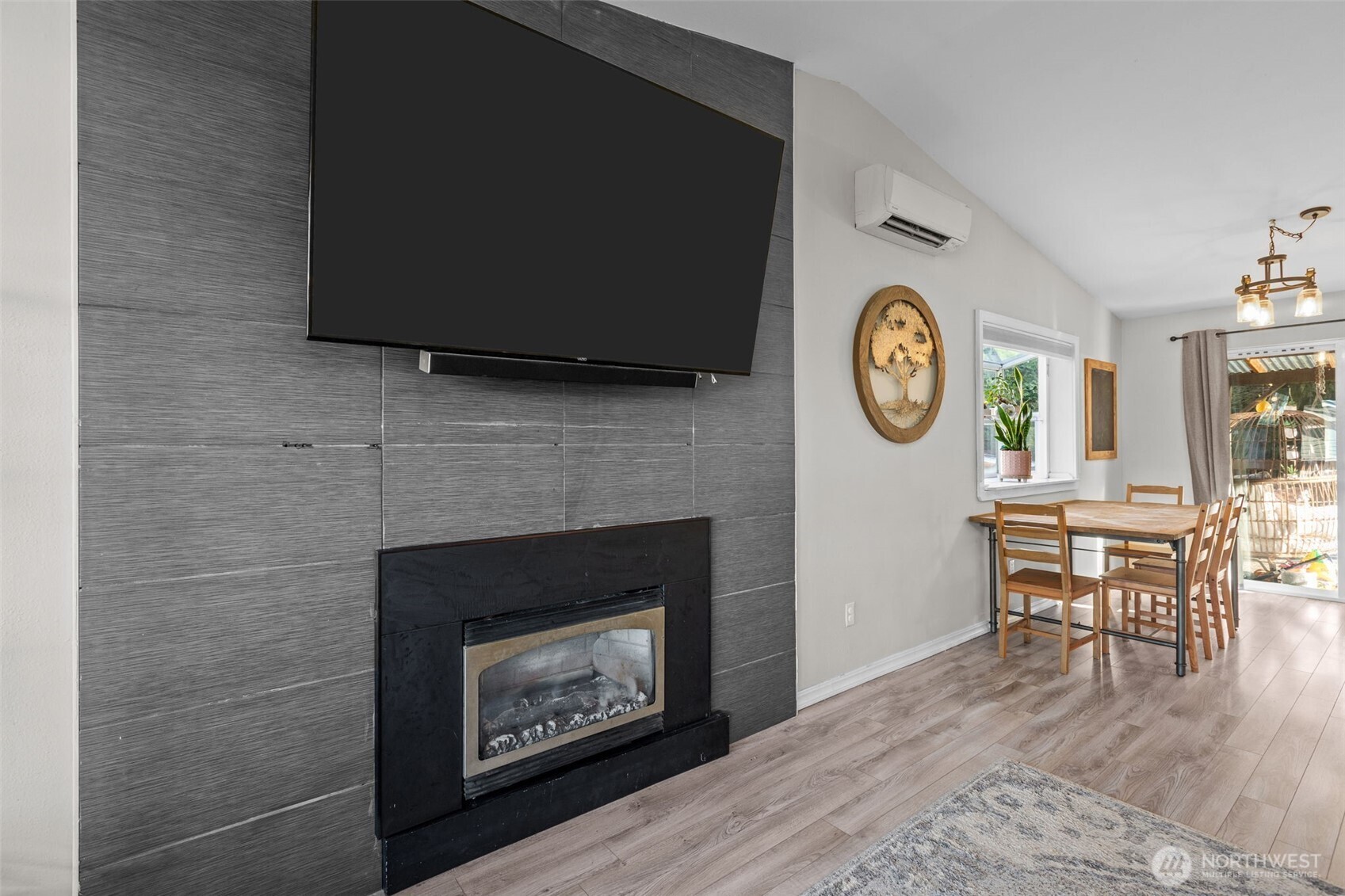20911 Ronning Road Arlington, WA 98223 - Photo 6 of 40 a living room with a fireplace a flat screen tv and furniture