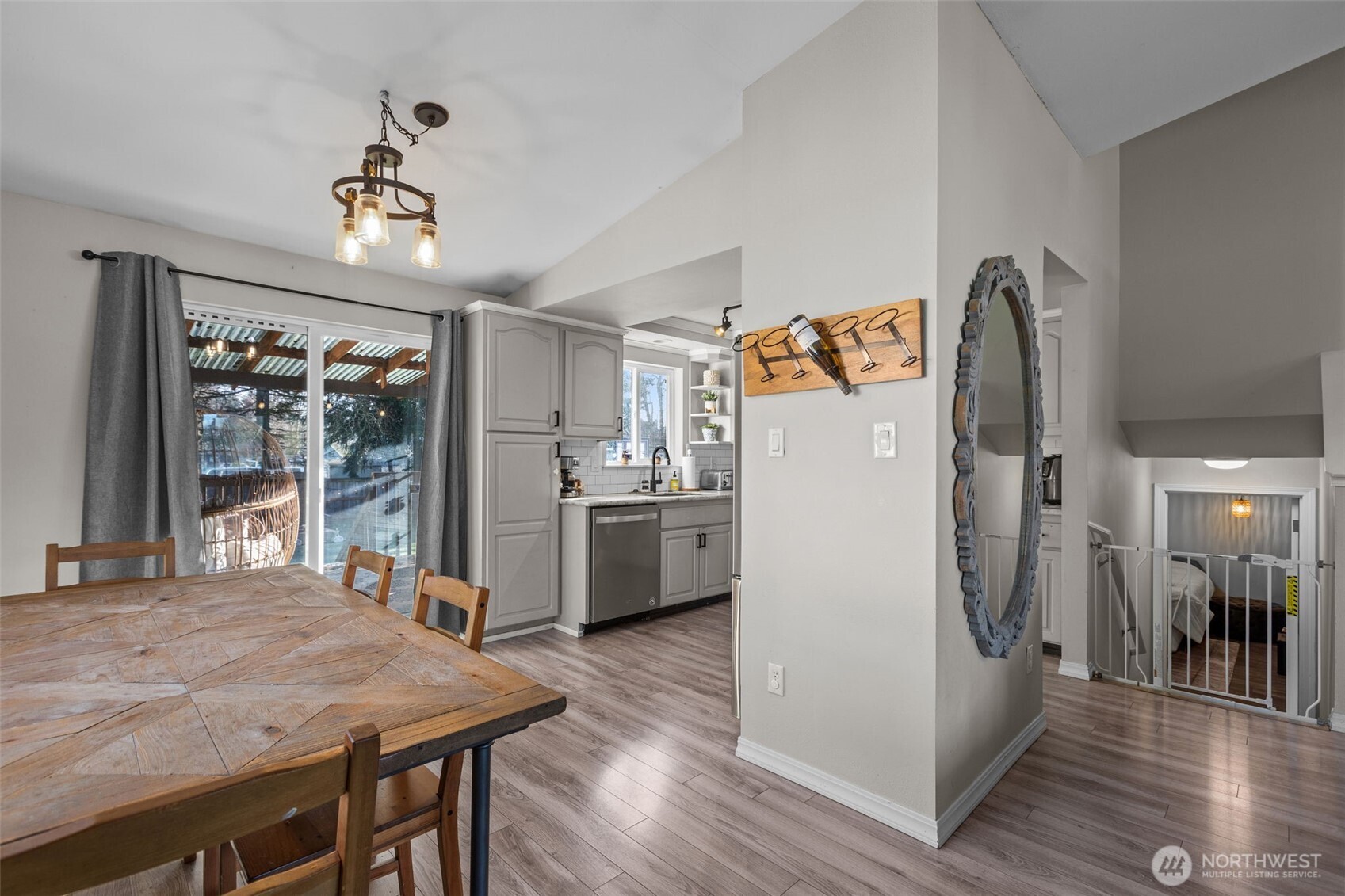 20911 Ronning Road Arlington, WA 98223 - Photo 8 of 40 a kitchen with stainless steel appliances granite countertop a refrigerator a sink dishwasher a stove and a dining table with wooden floor