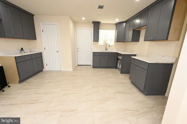 a large kitchen with a cabinets and wooden floor