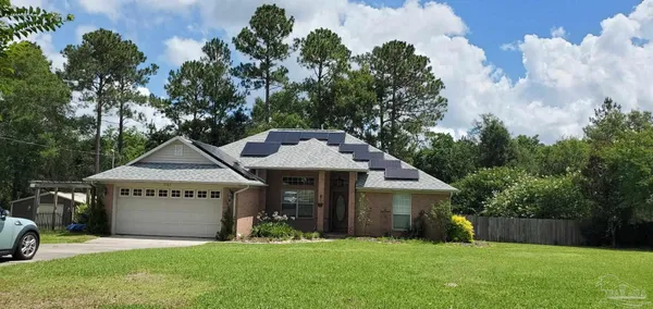 a view of a house with a yard and tree s