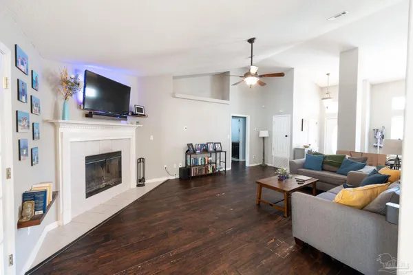 a bedroom with a large bed and a flat tv screen on dresser