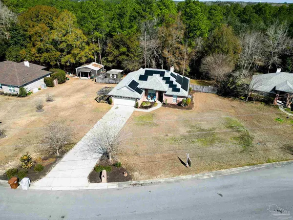 a view of a house with wooden deck and furniture
