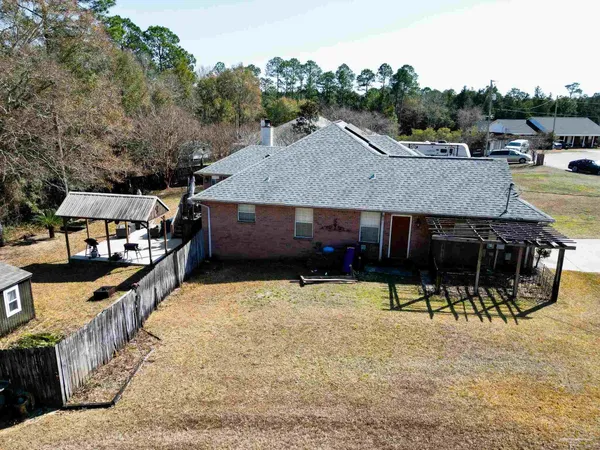 a view of a house with backyard and sitting area