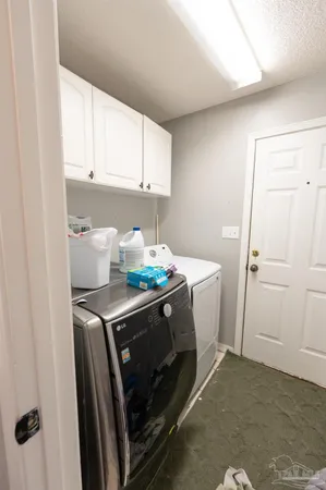 a bedroom with a bed a mirror and a large window with the potted plants