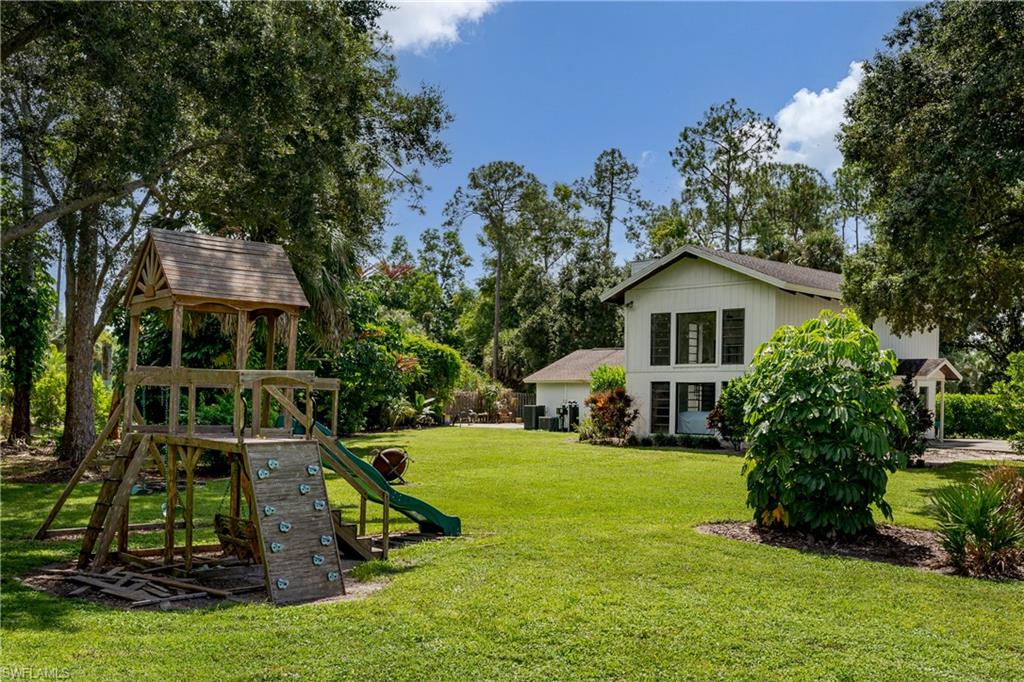 3301 31st Avenue Southwest Naples, FL 34117 - Photo 20 of 22 a view of a house with a yard and sitting area