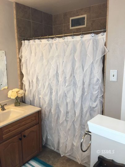 217 Rancho Street Ridgecrest, CA 93555 - Photo 14 of 25 a bathroom with a sink and a mirror