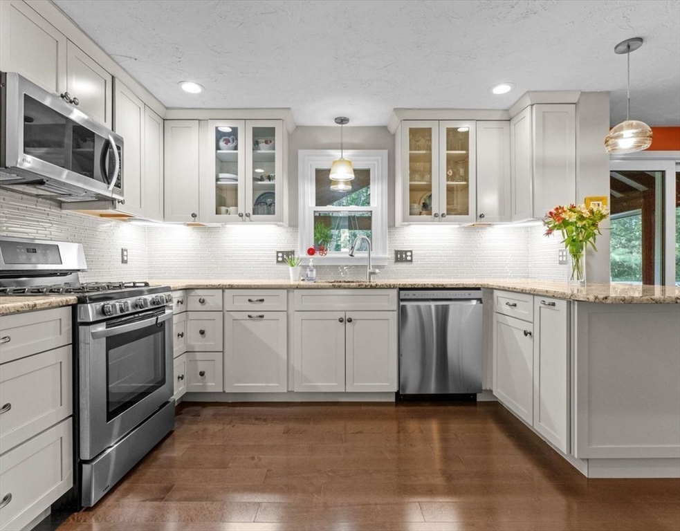 9 Pleasantview Terrace Framingham, MA 01701 - Photo 2 of 35 a kitchen with granite countertop a sink stainless steel appliances and cabinets