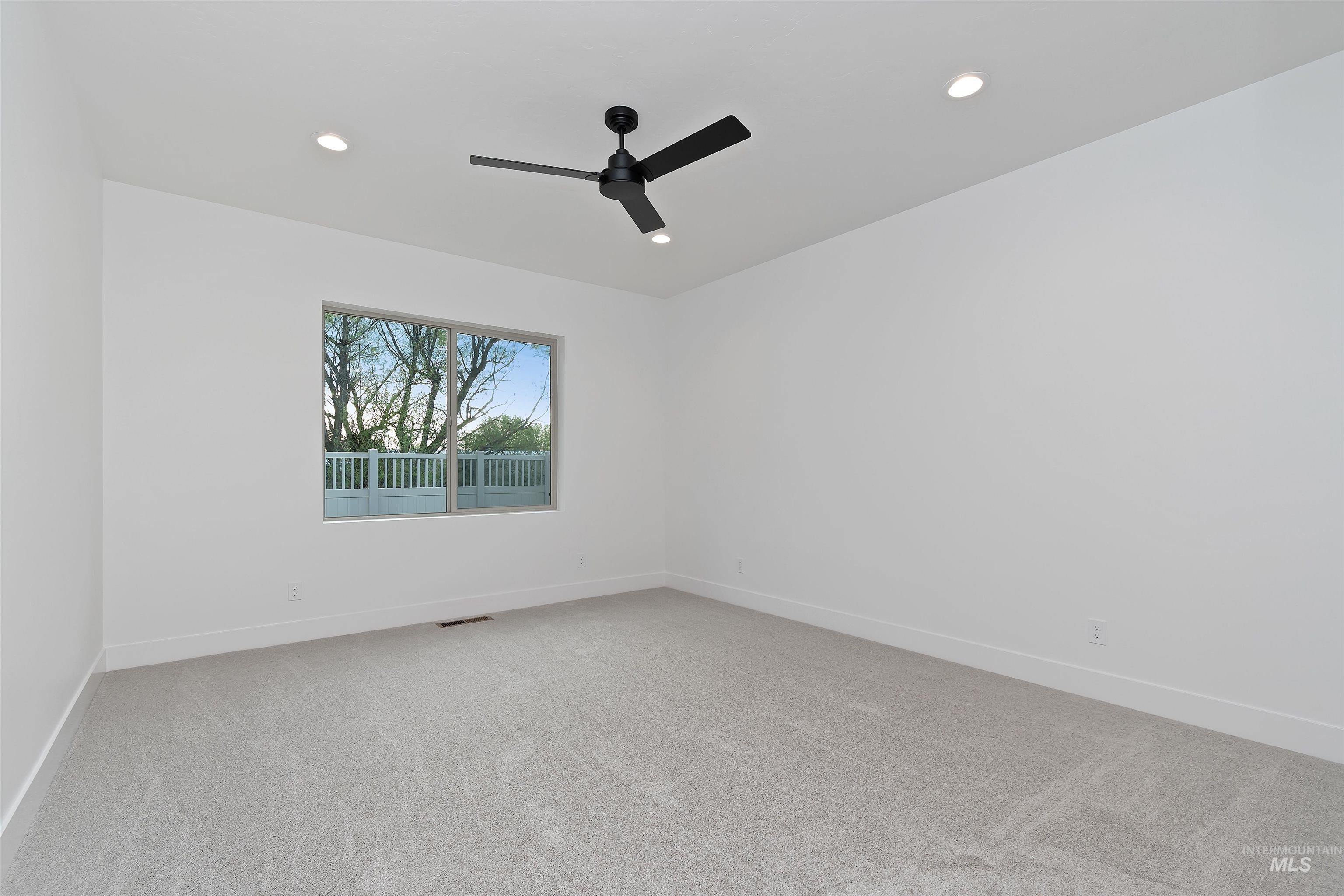 4302 Tropic Way Caldwell, ID 83607 - Photo 19 of 32 Empty room featuring light colored carpet, a ceiling fan, and recessed lighting