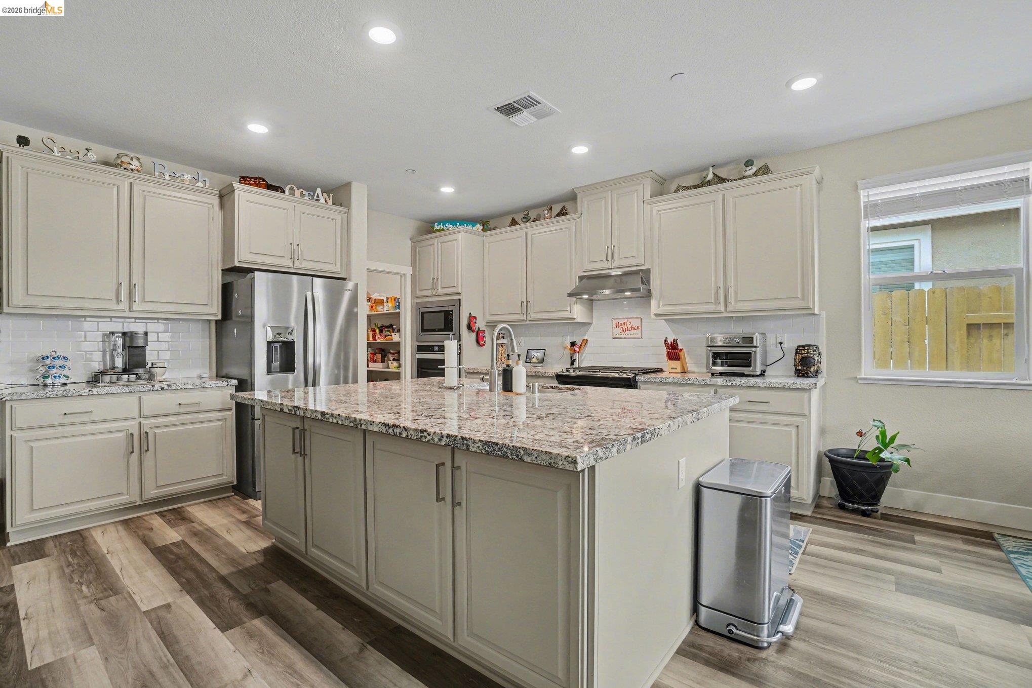 4585 Prairie Path Rio Vista, CA 94571 - Photo 7 of 45 a kitchen with kitchen island granite countertop appliances cabinets and a sink