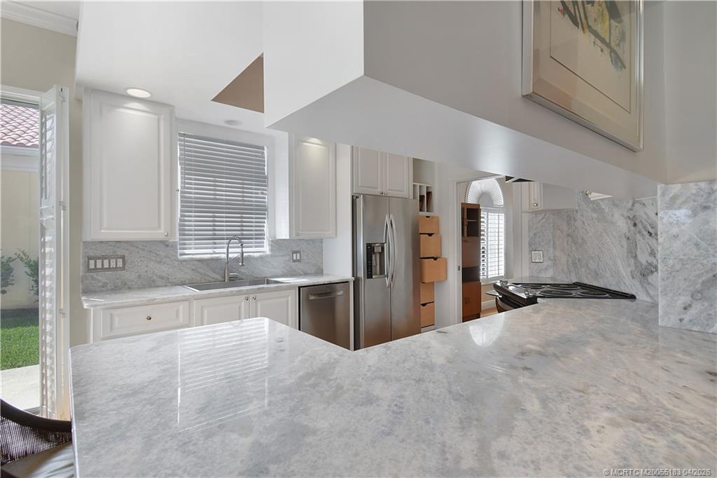 1494 Southwest Balmoral Trace Stuart, FL 34997 - Photo 15 of 45 Kitchen with Granite counters and back splace