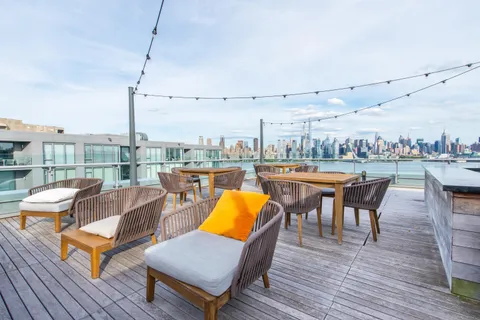 a balcony with furniture and wooden floor