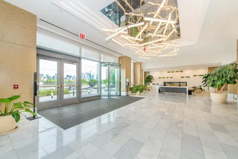 a lobby with furniture and a floor to ceiling window