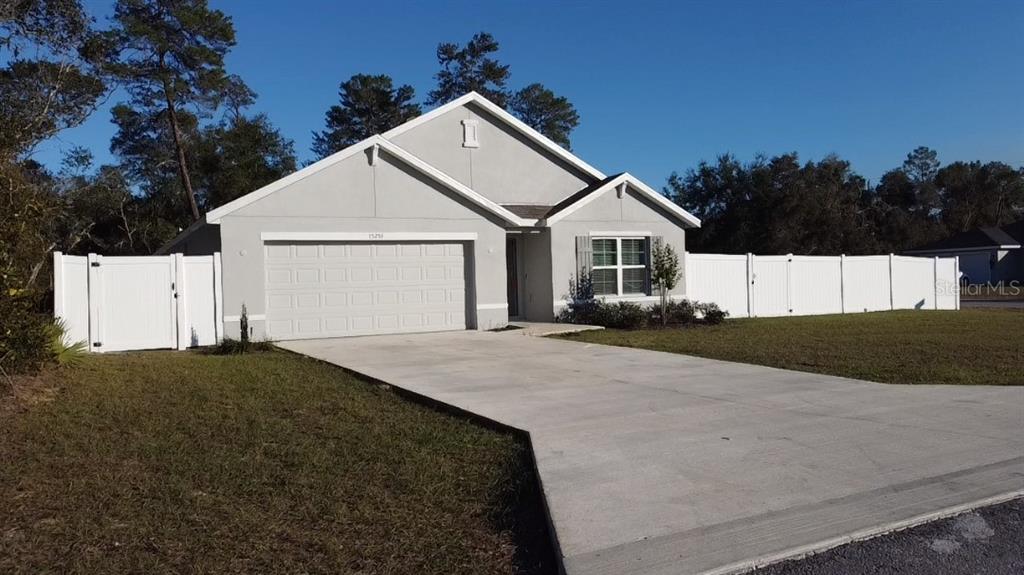 15253 Southwest 28th Avenue Road Ocala, FL 34473 - Photo 2 of 13 a front view of a house with a yard and garage