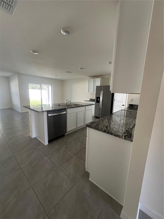 15253 Southwest 28th Avenue Road Ocala, FL 34473 - Photo 5 of 13 a kitchen with stainless steel appliances granite countertop a sink and a stove