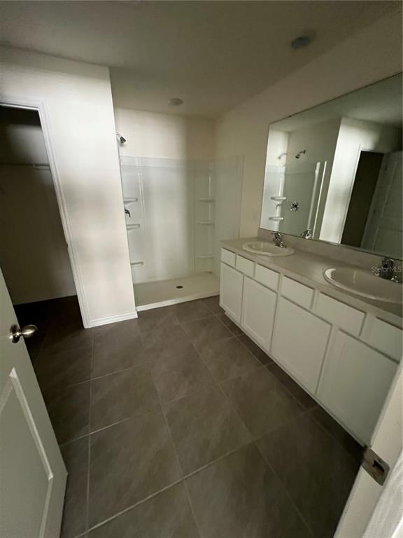 15253 Southwest 28th Avenue Road Ocala, FL 34473 - Photo 7 of 13 a bathroom with a double vanity sink a toilet and a mirror