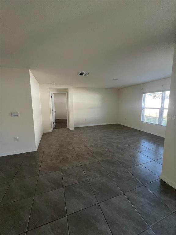 15253 Southwest 28th Avenue Road Ocala, FL 34473 - Photo 8 of 13 a view of empty room with window and wooden floor