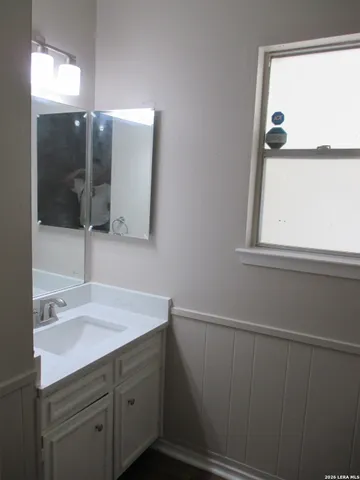 a bathroom with a sink and a mirror