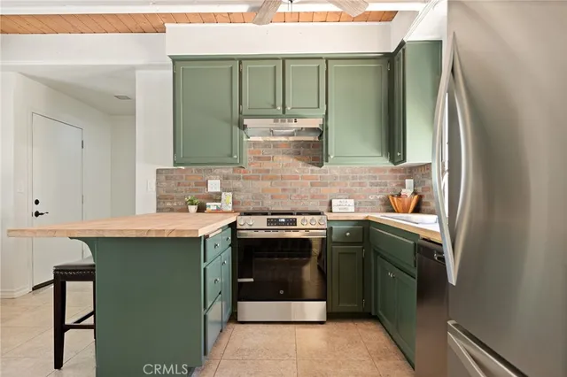 a kitchen with stainless steel appliances granite countertop a stove and a refrigerator
