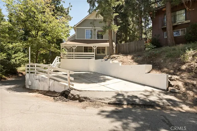 a front view of a house with a yard covered with snow