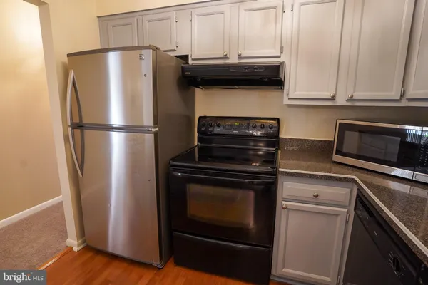 a kitchen with appliances and cabinets