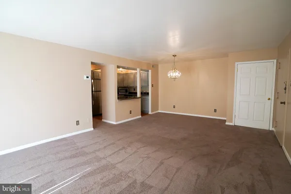 a view of a big room with closet and windows