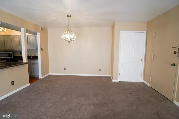 a view of a kitchen with an empty space and a window