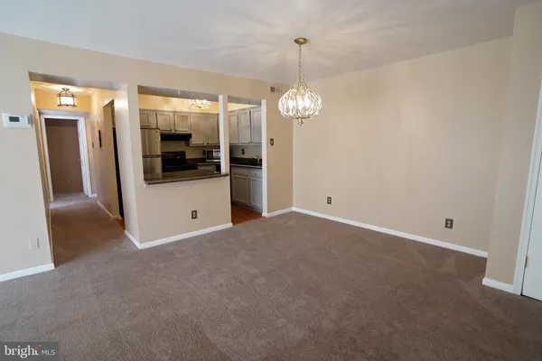 a view of a room with a flat screen tv and windows