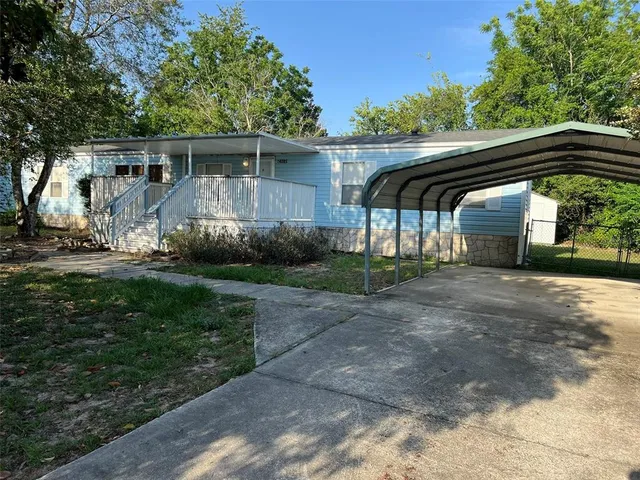 a view of house with a yard