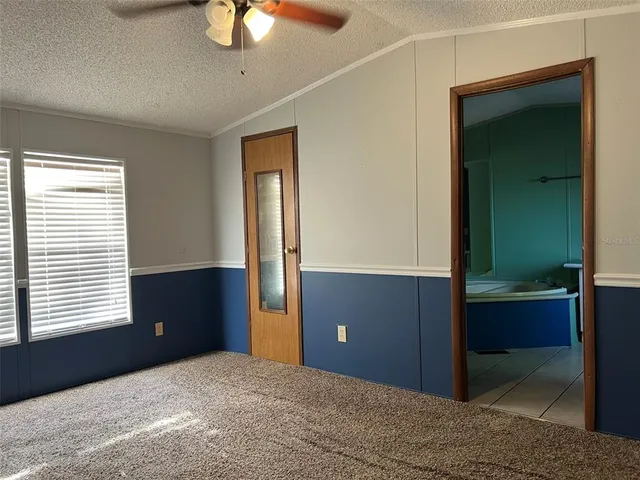 a bedroom with window walk in closet and a bathroom