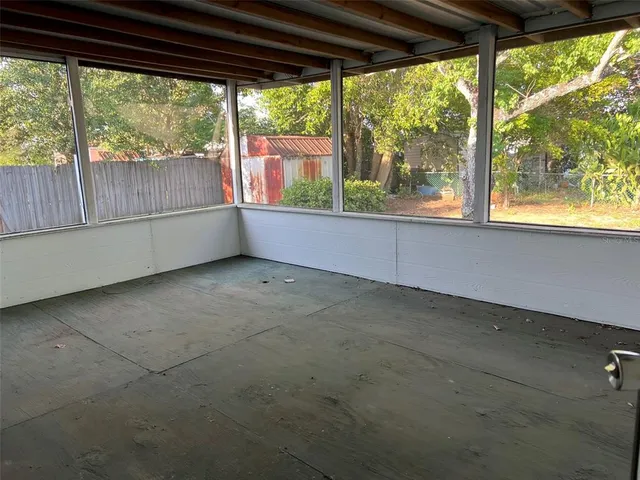 an empty room with large windows