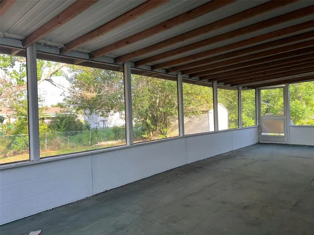 a view of room with large windows and stairs