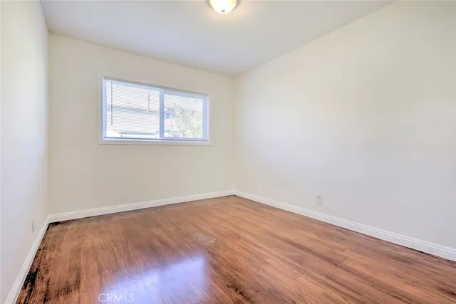 an empty room with wooden floor