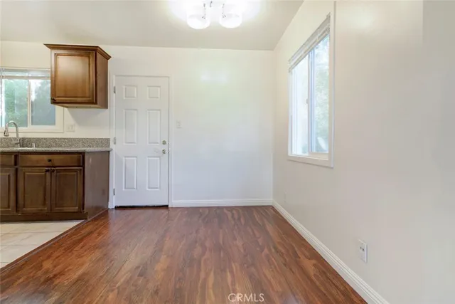 a kitchen with stainless steel appliances granite countertop a sink and a wooden cabinets
