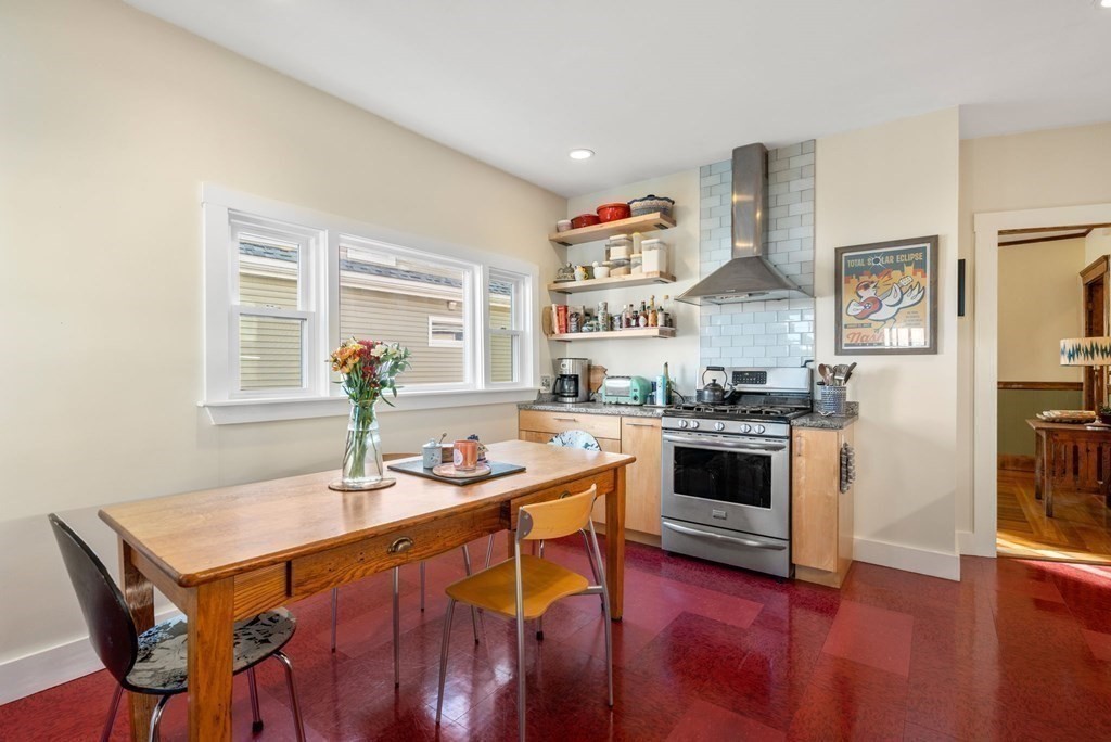 89 Bromfield Road Somerville, MA 02144 - Photo 14 of 41 a kitchen with stainless steel appliances granite countertop a stove a sink and a refrigerator