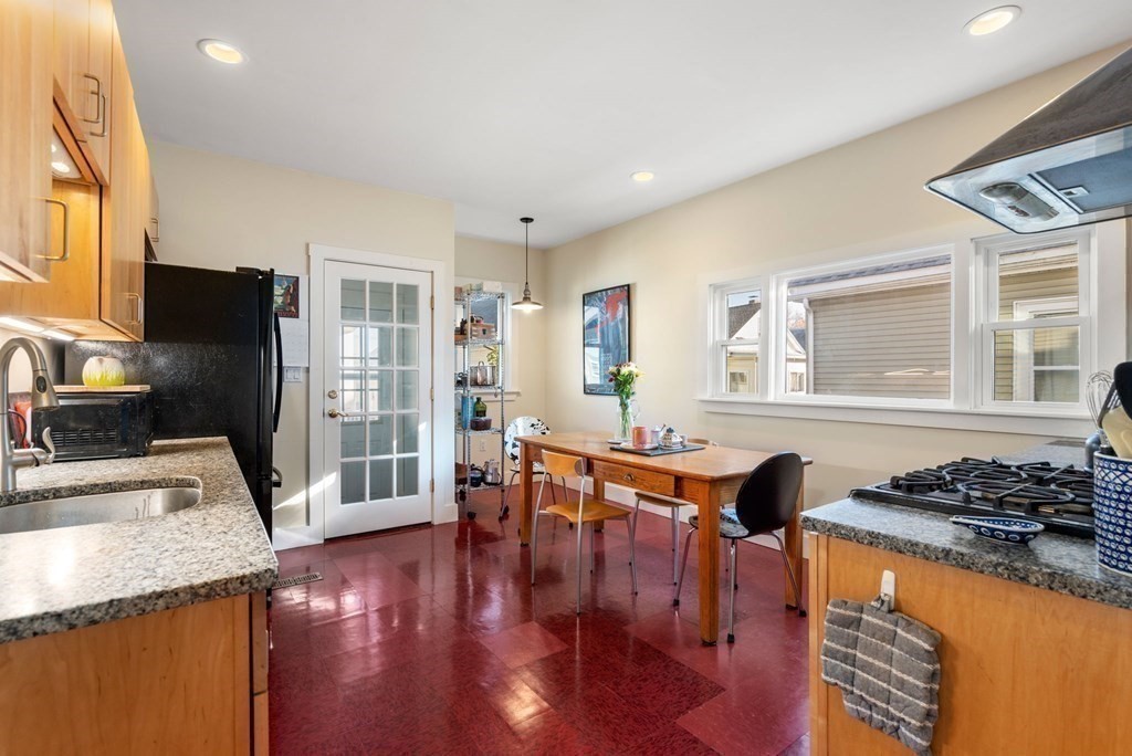 89 Bromfield Road Somerville, MA 02144 - Photo 16 of 41 a kitchen with stainless steel appliances granite countertop a stove and a refrigerator