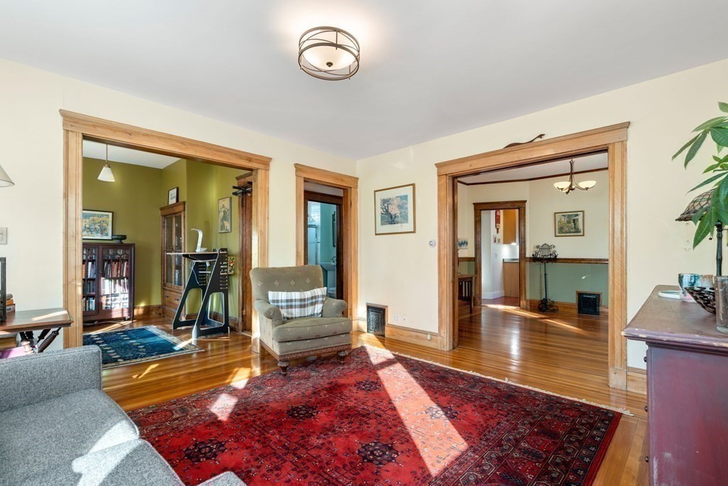 89 Bromfield Road Somerville, MA 02144 - Photo 18 of 41 a living room with furniture rug and a table