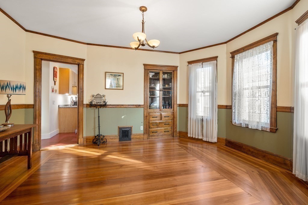 89 Bromfield Road Somerville, MA 02144 - Photo 19 of 41 a view of a livingroom with wooden floor and a ceiling fan