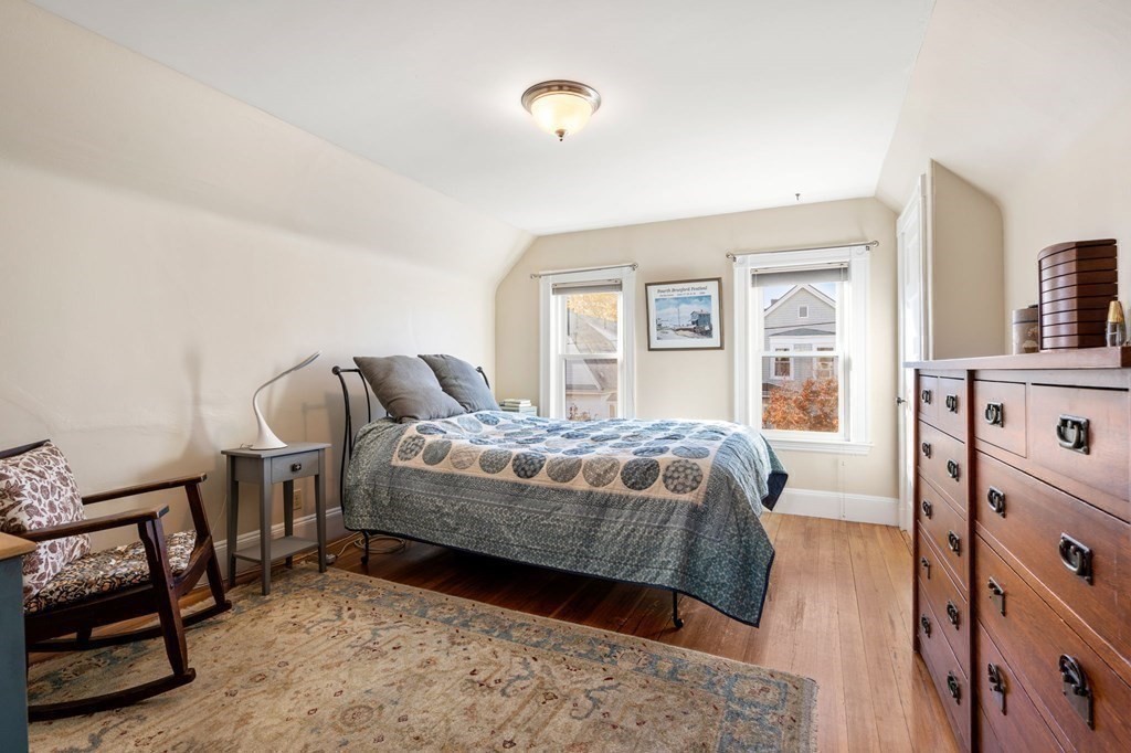 89 Bromfield Road Somerville, MA 02144 - Photo 21 of 41 a bedroom with a bed and a flat tv screen on dresser