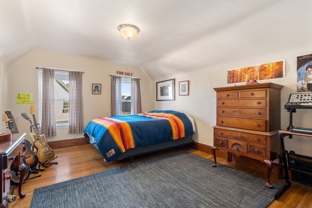 89 Bromfield Road Somerville, MA 02144 - Photo 23 of 41 a bedroom with a bed and wooden floor