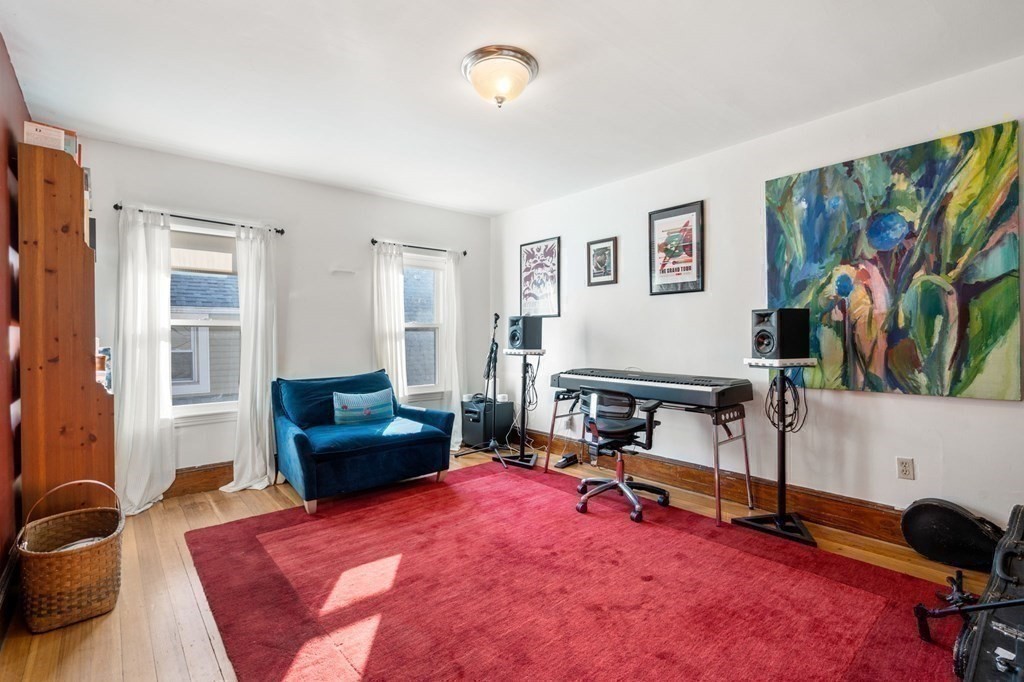 89 Bromfield Road Somerville, MA 02144 - Photo 24 of 41 a living room with furniture and a flat screen tv