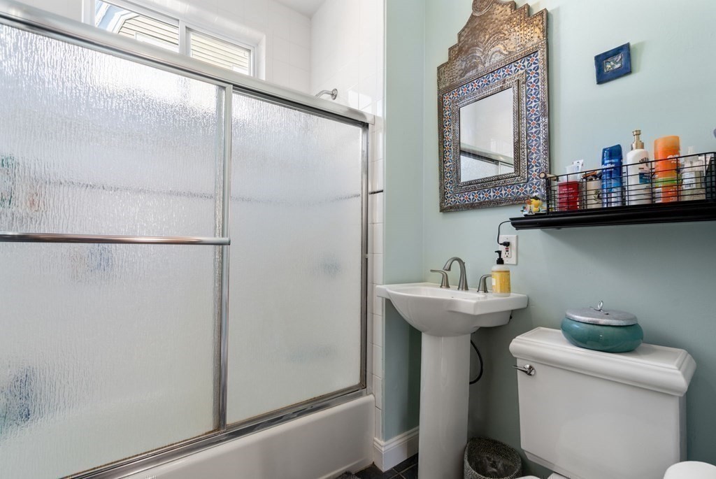 89 Bromfield Road Somerville, MA 02144 - Photo 25 of 41 a bathroom with a sink and mirror with toilet