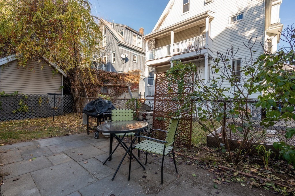 89 Bromfield Road Somerville, MA 02144 - Photo 36 of 41 a view of a chairs and table in backyard