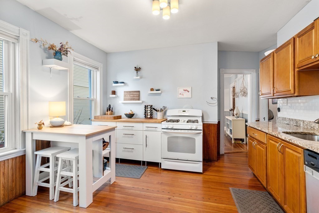 89 Bromfield Road Somerville, MA 02144 - Photo 4 of 41 a kitchen with a stove top oven sink and cabinets
