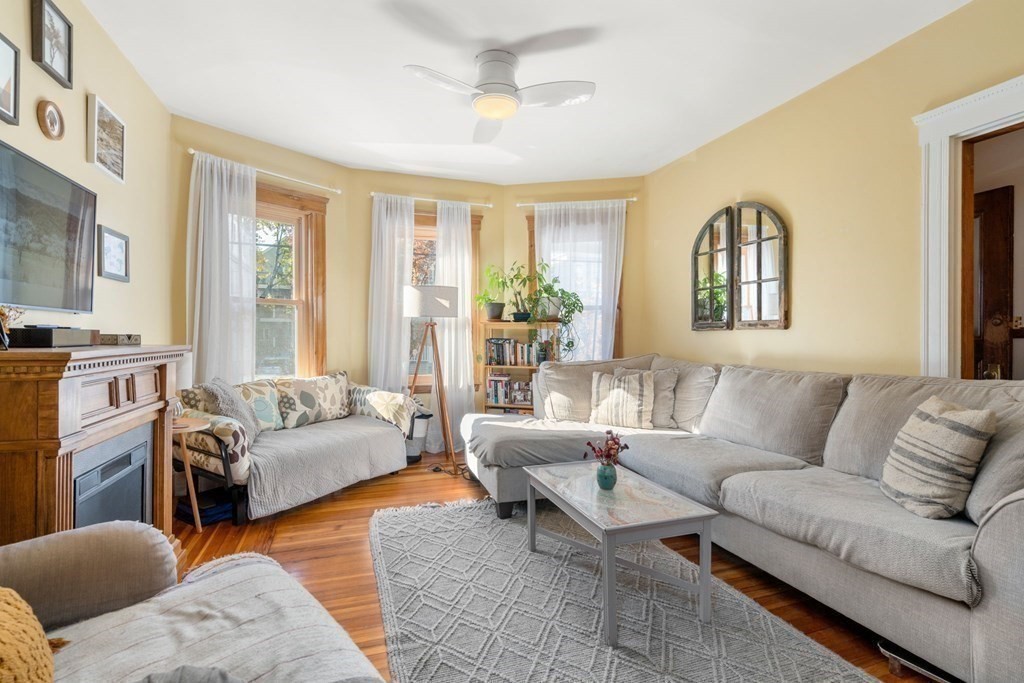 89 Bromfield Road Somerville, MA 02144 - Photo 7 of 41 a living room with furniture and a large window